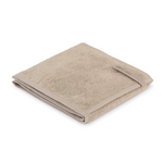 A folded beige dog towel with pockets, made of organic cotton, laid out on a surface.