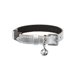 A silver cat collar made of metallic silver leather with black suede lining and a bell attached to the breakaway safety catch.