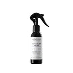 A black spray bottle labeled 'Detangler Spray & Leave - In Conditioner For Dogs' with white and green text, and the brand 'Wool & Whiskers' visible.