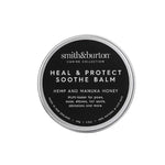 A container of Smith & Burton Heal & Protect Soothe Balm for dogs, with labels indicating its use for paws, nose, hot spots, and more.